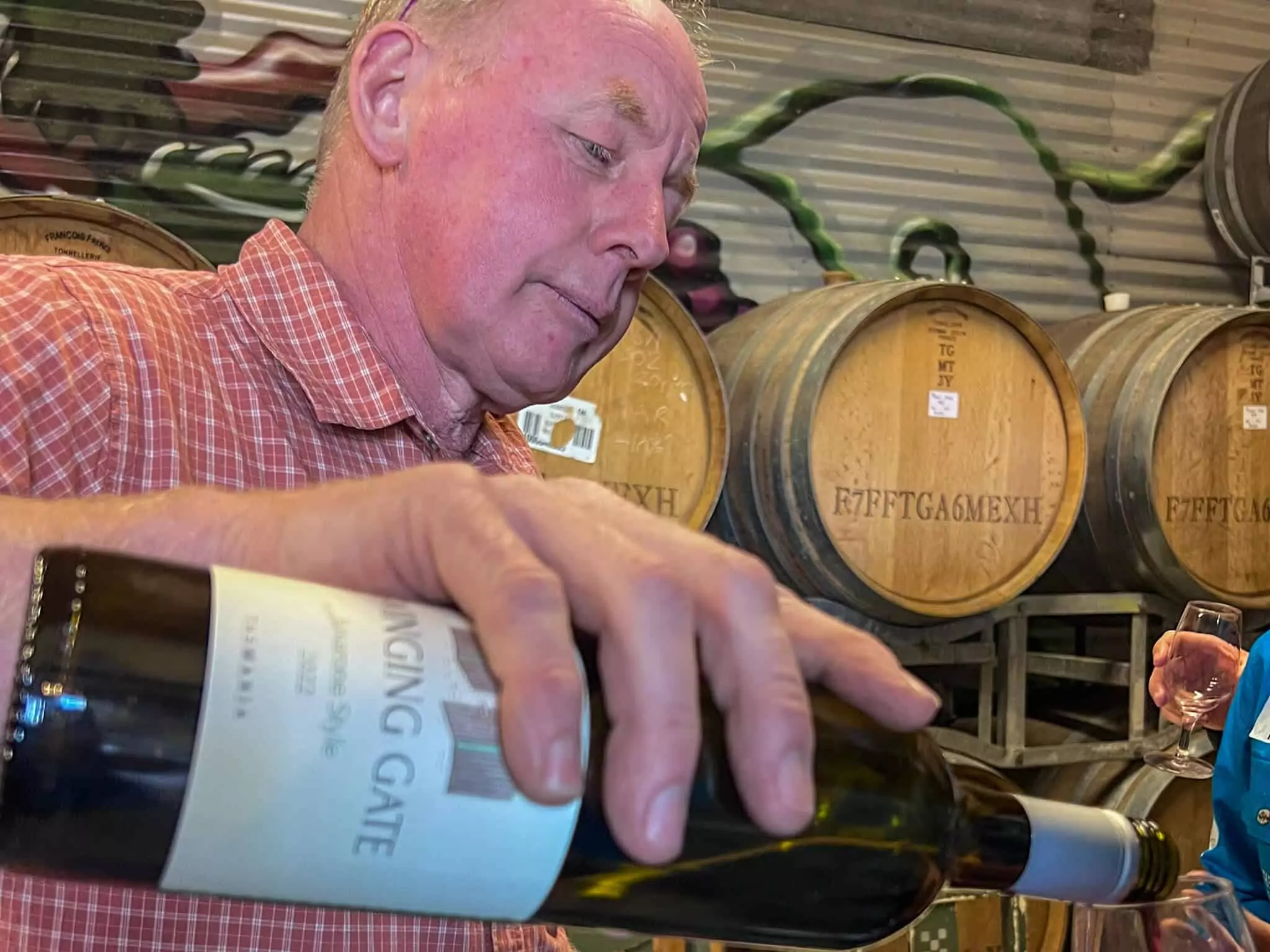 Pouring a glass of wine at the Swinging Door winery