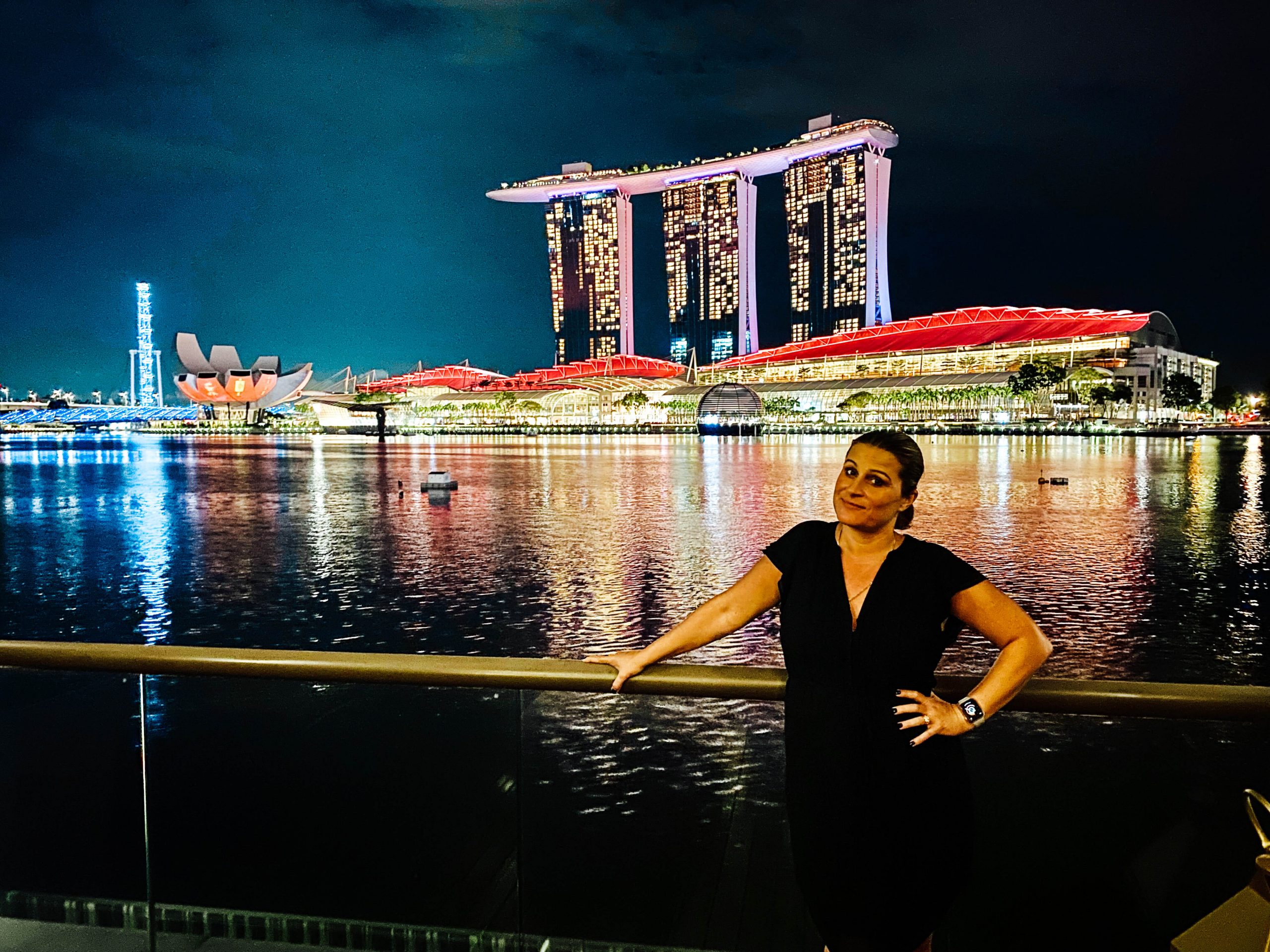 standing in front of the marina bay sands at night