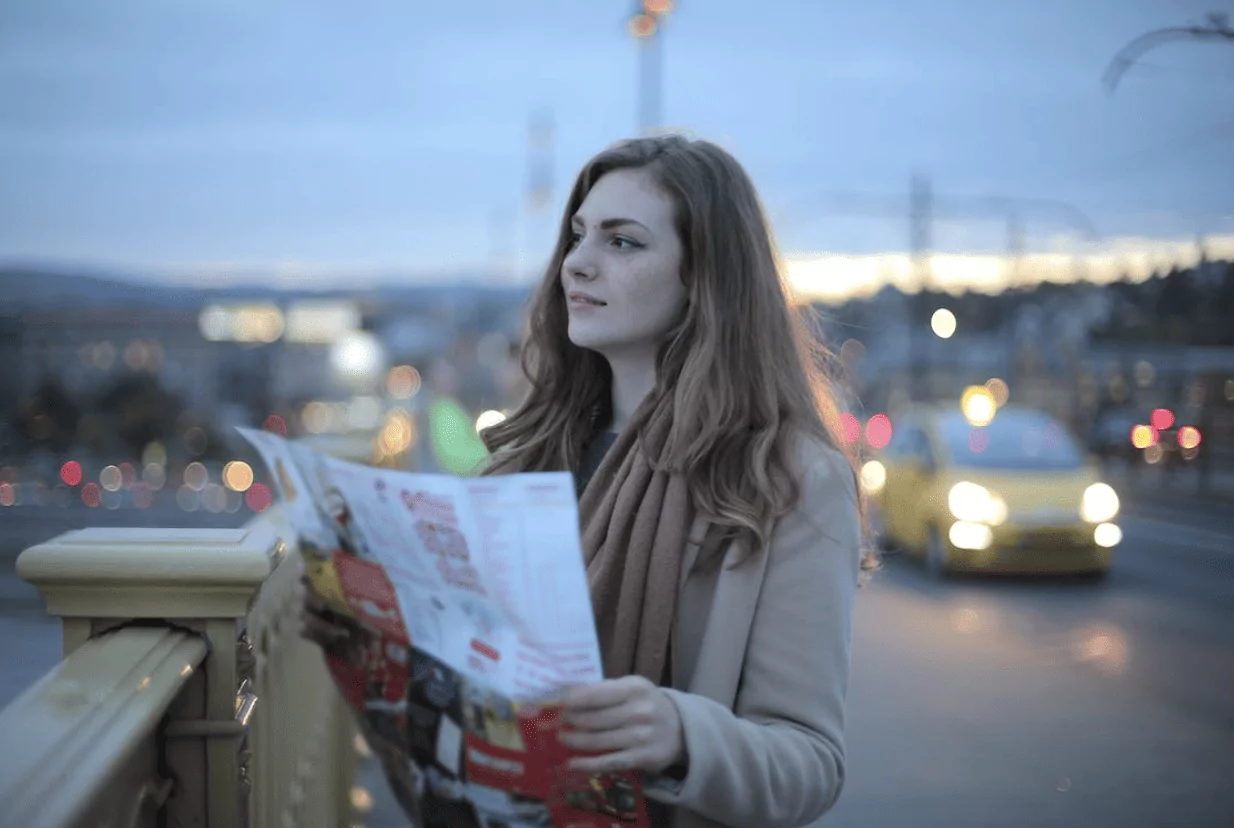 2024 Travel trends - standing with a map while travelling