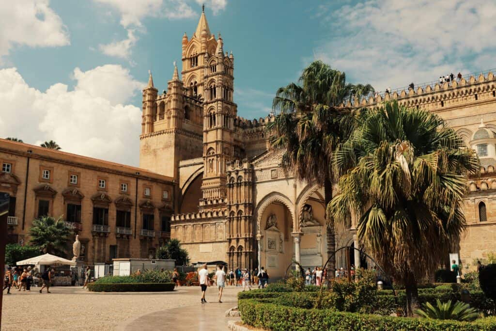 Explore the stunning architecture of Palermo Cathedral in Sicily, Italy, under a bright blue sky.
