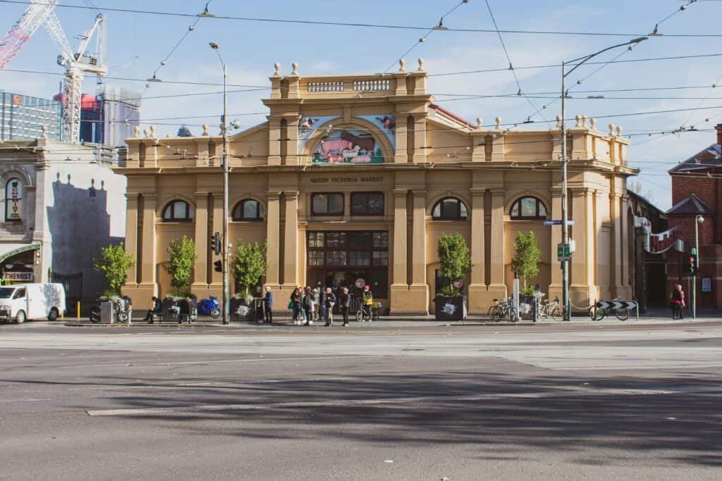 Street view of Queen Victoria Market with people and bicycles in Melbourne, Australia.