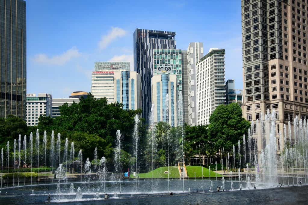 Urban landscape with skyscrapers and fountain in Kuala Lumpur, Malaysia.