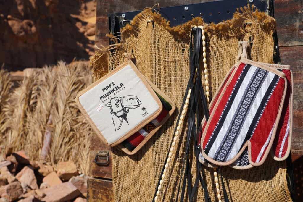 Close-up of traditional handcrafted souvenirs displayed in an outdoor desert market.