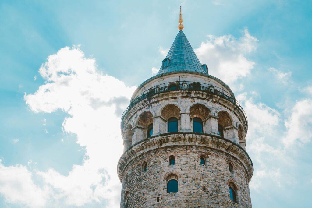A captivating view of Galata Tower under a bright blue sky in Istanbul, Turkey.