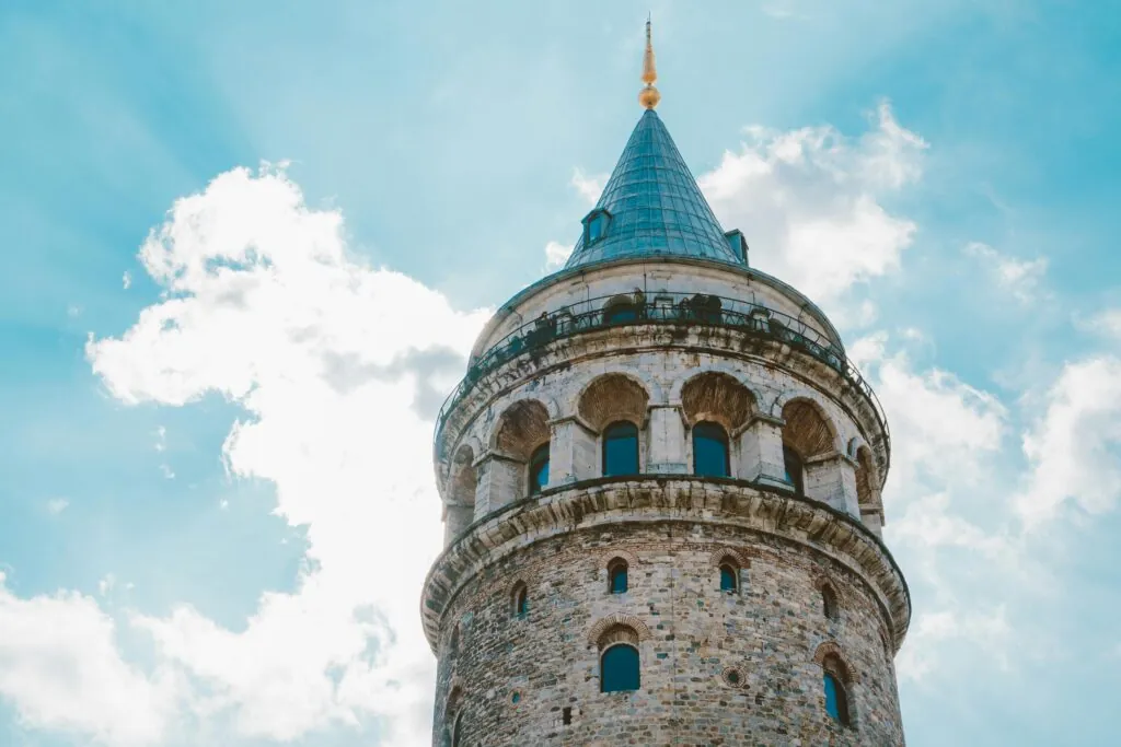 A captivating view of Galata Tower under a bright blue sky in Istanbul, Turkey.