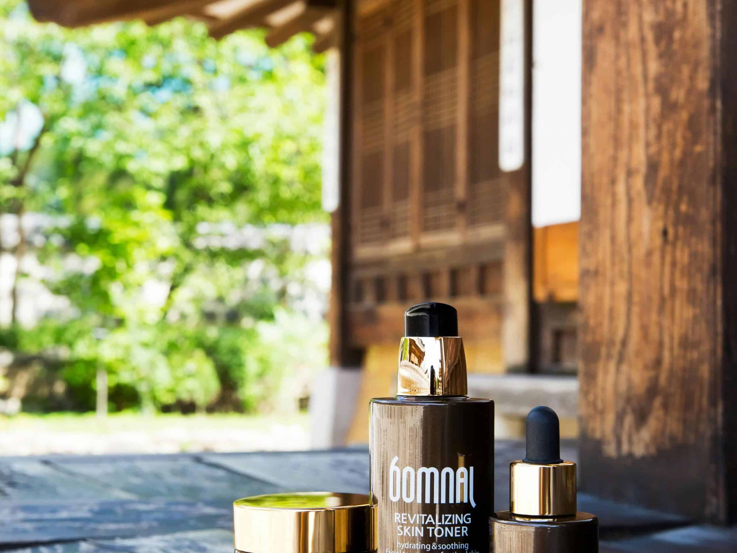 High-quality Korean skincare products displayed outdoors against a traditional architecture backdrop.
