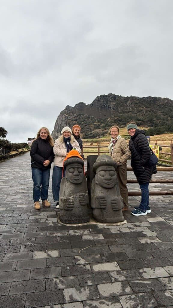 jeju island, standing infront of a statue in jeju island