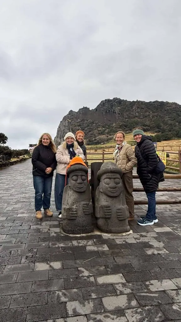 jeju island, standing infront of a statue in jeju island