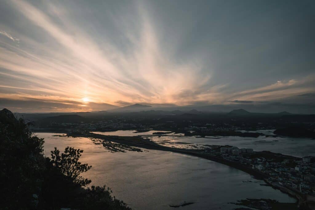Captivating sunrise view over Seongsan, Jeju Island with striking seascape and clouds.