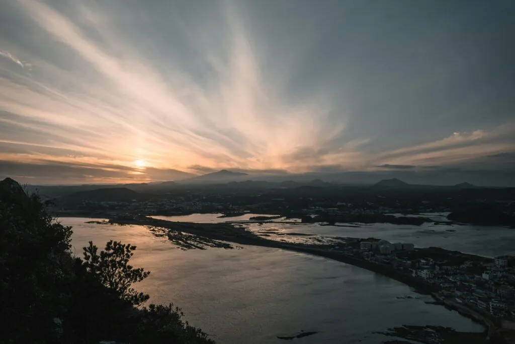 Captivating sunrise view over Seongsan, Jeju Island with striking seascape and clouds.