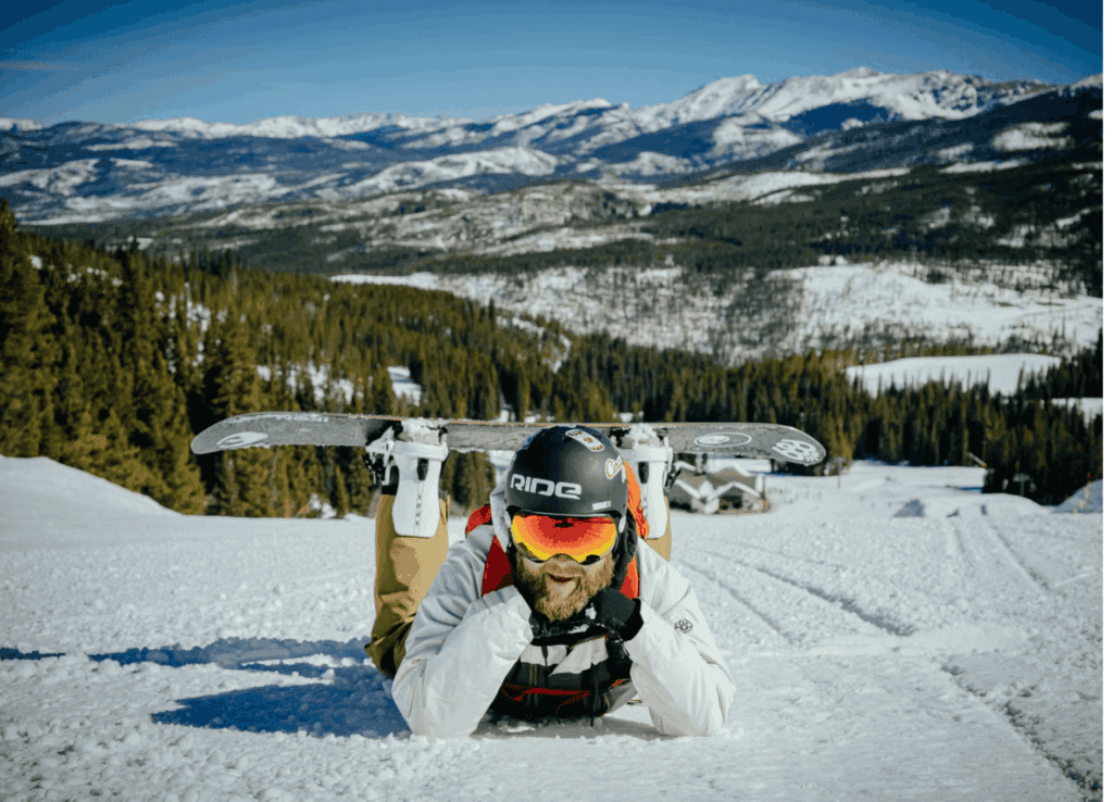 Breckenridge mountain with snowboarder laying down