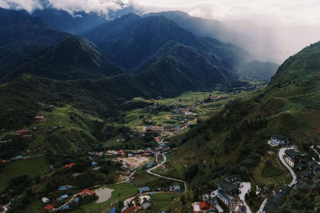 Stunning aerial view of Lào Cai's lush valley and mountains, captured during the day.
